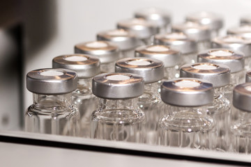 Glass vials for liquid samples. Laboratory equipment for dispensing fluid samples. - obrazy, fototapety, plakaty