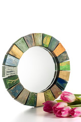 Interior design mirror handmade in wooden frame with bouquet of spring tulips