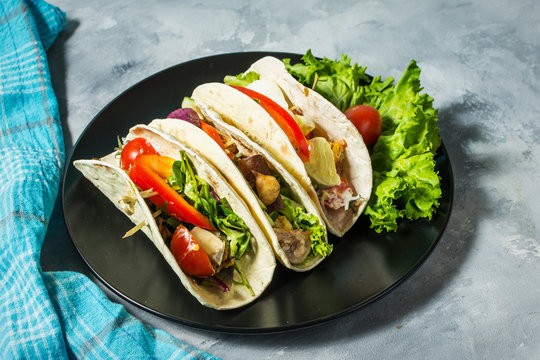 Fresh delicious mexican tacos on concrete rustic background