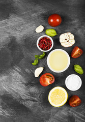 Various spices, herbs and vegetables on dark background. Top view, copy space. Food background