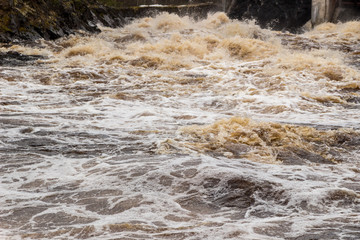 Stormy mountain river with large waves