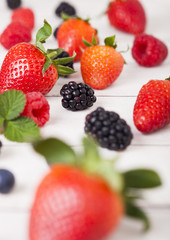 Obraz na płótnie Canvas Freash organic healthy berries on wood background