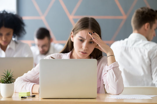 Frustrated stressed woman feeling upset about online problem or negative message looking at laptop screen, sad employee or worried student troubled with difficult task concerned about bad email news
