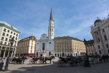 Fototapeta premium Horse carriages on St. Michael square (Michaelerplatz), Vienna, Austria