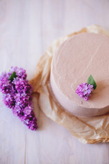 Chocolate cake with lilac decor.