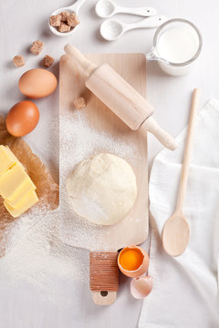 Dough preparation recipe for bread, pizza, pasta, cookies or pie ingridients, food flat lay on kitchen table background. Working with butter, milk, yeast, flour, eggs, sugar pastry or bakery cooking.