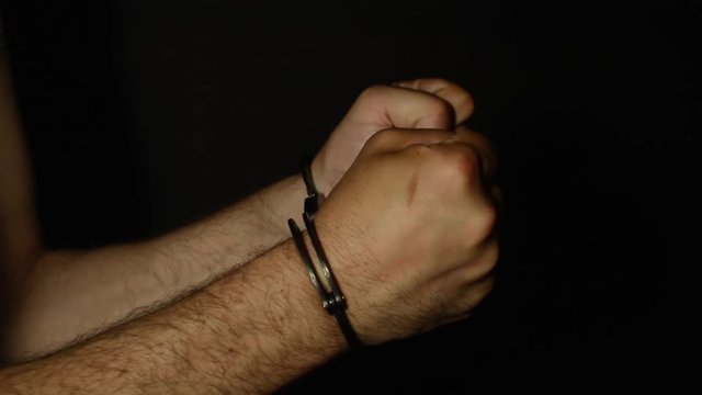 Men's hands in handcuffs