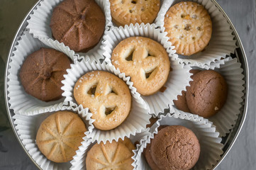 Background with almond and chocolate cookies and on grey vintage table, food concept with copy space, top view