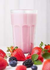 Milkshake glass with fresh summer berries smoothie