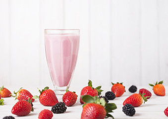 Milkshake glass with fresh summer berries smoothie