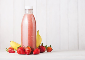 Plastic bottle with fresh summer berries smoothie