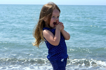 little girl on the beach laughing