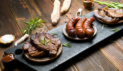 Delicious grilled meat on a dark background.