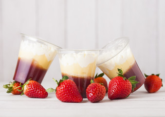 Plastic container with strawberry cream dessert