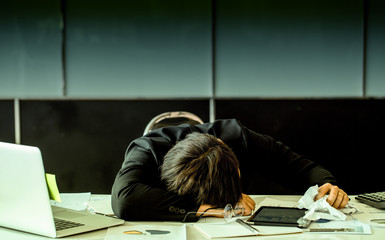 Married officer worked hard until he is nap at work. In his hand there is a crumpled paper.