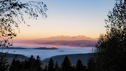 Landscape view of Spis castle and High Tatras mountains at sunrise, Slovakia