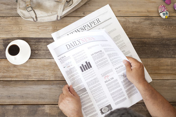 Naklejka premium reading newspaper at morning