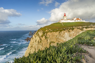 Fototapeta na wymiar Lighthouse on the cliffs on Cape Roca, Sintra - Cascais Natural Park, Portugal