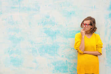 Portrait of girl with red glasses and yellow pullover