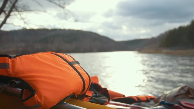 Lifejacket on the inflatable catamaran on the mountain river background