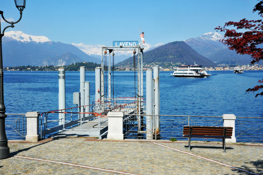 Laveno Mombello, Italy - April 18, 2018: Laveno Mombello, located in an natural gulf of Lake Maggiore in province of Varese, Ferry-boat approaching Laveno Mombello, Lake Maggiore