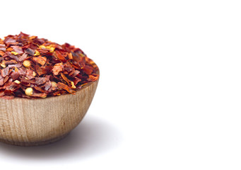 Crushed Red Pepper in a Wooden Bowl on a White Background