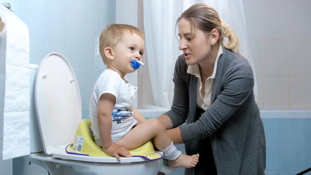 4k footage of cute baby boy learning how to use toilet with mother