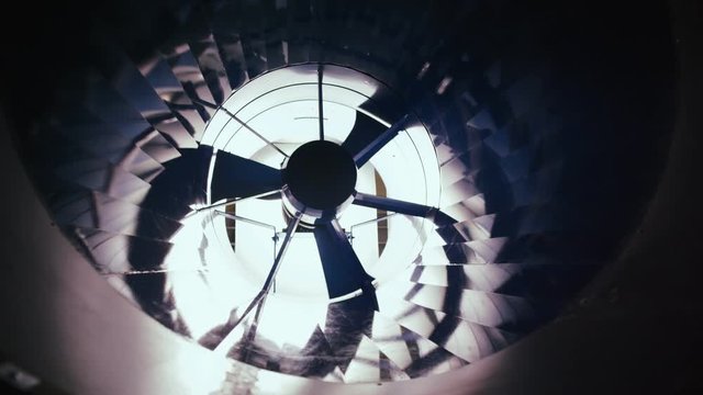 Rotating fan blades on ventilation fan on dark industrial background