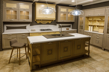 Interior of modern kitchen with beige cabinets