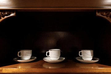 Interior of modern kitchen with white porcelain cups