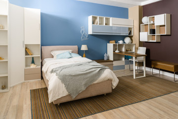 Bedclothes on bed in cozy bedroom in blue tones