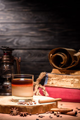 alcohol cocktail with coffee on wooden board, cinnamon sticks on table