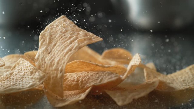 Adding salt on tortilla chips. Shot with high speed camera, phantom flex 4K. Slow Motion.