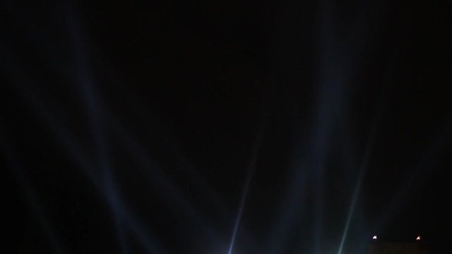 Searchlights shining beams of light into the sky 