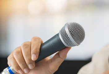 Seminar Speaking Conference Concept : Microphone of speech in seminar room or speaking conference hall light bokeh background. Speaker Business tedtalk is vocalized form of communication humans.