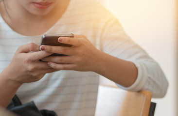 Online searching social networks by Smartphone Concept: Close-up Business woman holding mouse and using modern smartphone laptop device, hands typing text message to connect wifi for shopping online.