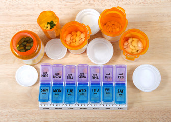 Pre-filling twice a day medication box with many pills. The importance of medication management cannot be overstated, especially when it comes to the care of seniors. Med boxes assist with management.