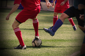 soccer player about to take away the ball from the opposite player