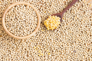 Soy milk and soy beans on wood background.