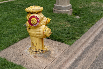 Old yellow fire hydrant with out-of-service sign