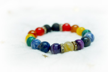
Colorful spectrum lucky stone bracelet bead on white towel background.fashion with believe in Add charm,property, healthy in wonderful life.