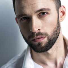 Handsome man in white shirt. Closeup portrait.