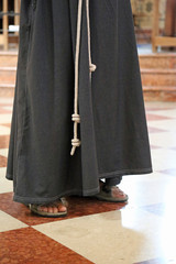 barefoot friar with sandals and brown habit in the cathedral