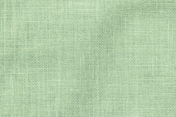 Fototapeta premium Hessian sackcloth woven texture pattern background in light pale green earth color