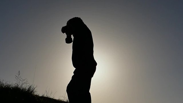 Man wear on gas mask outdoors silhouette slow motion
