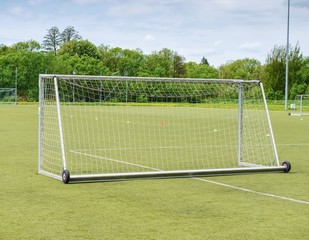 Football playground. Gate with  blue yellow nets, soccer football net.