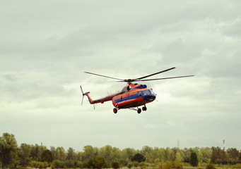 Fototapeta na wymiar red helicopter takes off