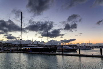 Fototapeta na wymiar Luxurious yachts at sunset in Auckland's harbour, New Zealand
