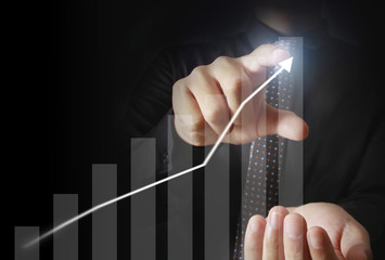 Businessman with financial symbols coming