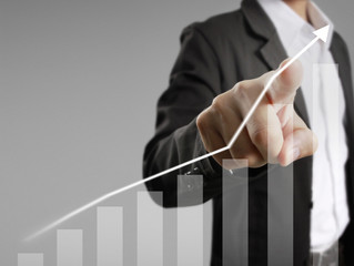 Businessman with financial symbols coming